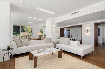 Open living room with modern white sofas